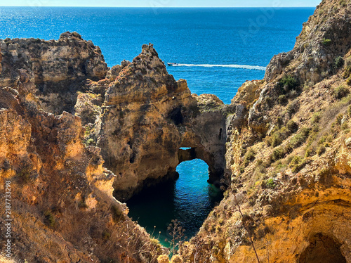 Picturesque headland with famous golden cliffs and sea grottoes in the town of Lagos, in the Algarve region. Portugal.