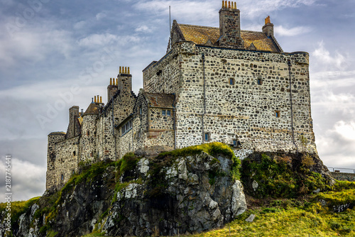 Fotografie Historic stone fortress perched on rugged volcanic rock promontory, traditional