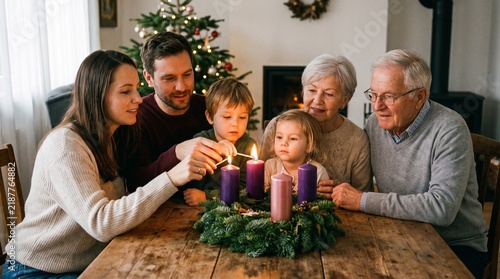 Multi-generational family lighting advent candles on a wreath during Christmas celebration at home