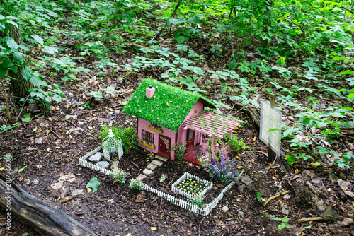 Miniature Fairy House Cabin and Campsite Display in Green Forest
