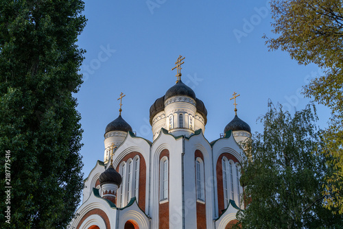 Bild auf Leinwand Traditional orthodox christian church with beautiful copper domes reaching towards clear blue sky