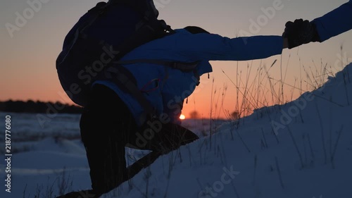 Achieve your goal. Teamwork business. Struggle for survival. Climbers holding hands reach summit. Business team victory. Lend helping hand, partner. Travelers climbing mountain together. Silhouettes