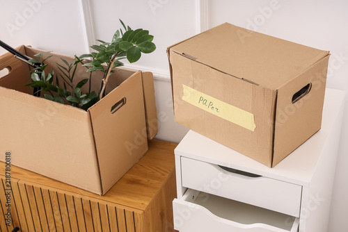 Картината върху платно Relocation and office move, cardboard boxes with personal belongings and office