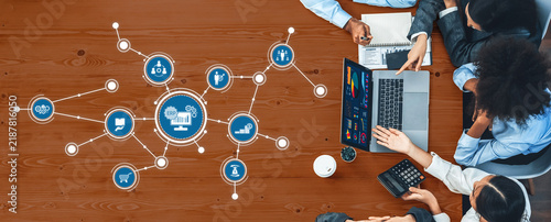 Konstfotografi A top-down view of a diverse team engaged in a collaborative meeting, utilizing laptops and digital tools to analyze data and develop business strategies effectively