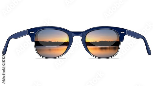 Classic blue sunglasses featuring a scenic sunset reflection on the lenses isolated on a clean white background