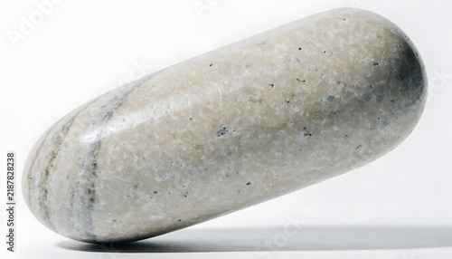 Plakat Smooth oblong pebble casts a soft shadow on a plain white background.