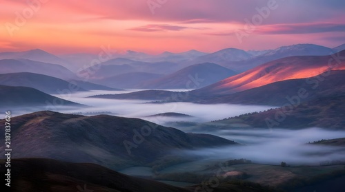 Misty valleys at sunrise or sunset vibrant sky colors over mountainous landscape during golden hour