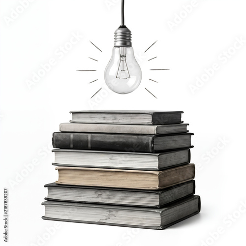 Light bulb shining over a stack of antique books representing wisdom and inspiration for academic educational marketing and creative