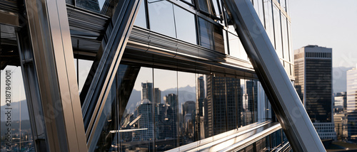 Double Exposure of Modern Glass Skyscraper Reflecting Vibrant City Skyline at Sunset