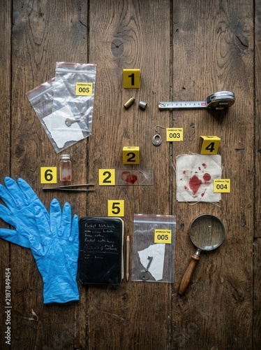 Crime Scene Investigation Kit And Evidence Collection On Wooden Background