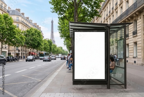 Blank vertical advertising billboard mockup on a modern bus shelter along a street in Paris with the Eiffel Tower in the background.