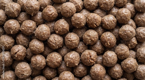 Top down close up view of an abundant pile of freshly cooked beef meatballs, savory meat protein food texture and pattern background