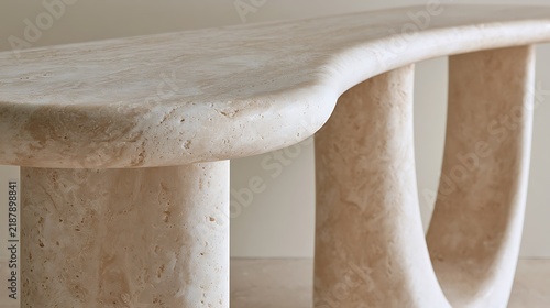 Minimalist modern travertine stone console table with curved organic design.
