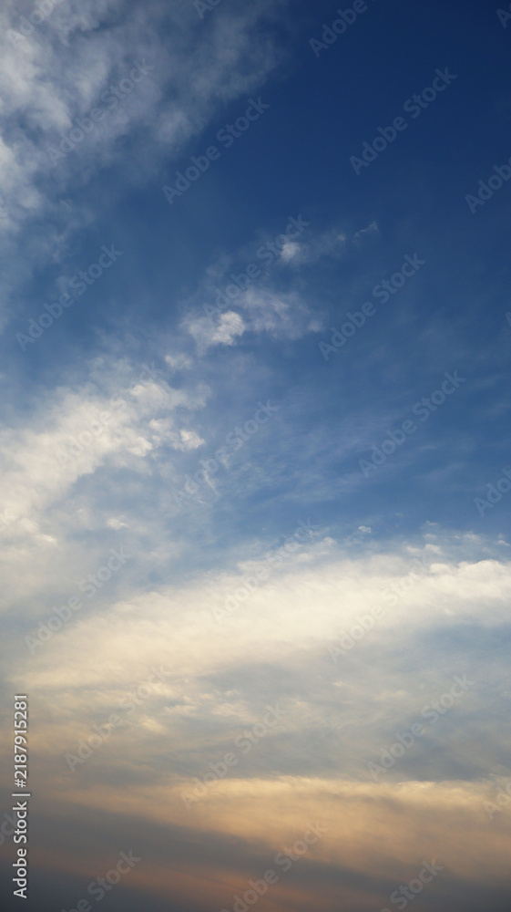 Obraz premium Vertical Blue Sky with Golden Sunset Clouds Full Frame Background