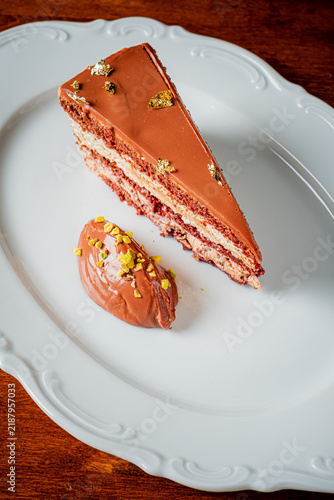 Quadro su tela Indulging in a decadent chocolate layer cake with rich mousse on a white platter