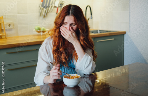 Bild auf Leinwand Pregnant woman experiencing nausea and food aversion while eating a meal at home, illustrating morning sickness and common pregnancy symptoms