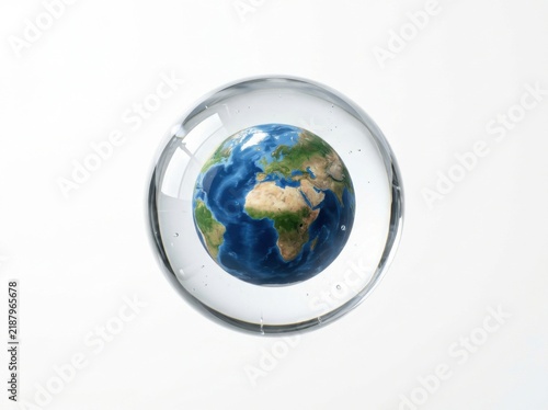 Earth globe suspended within a clear glass sphere