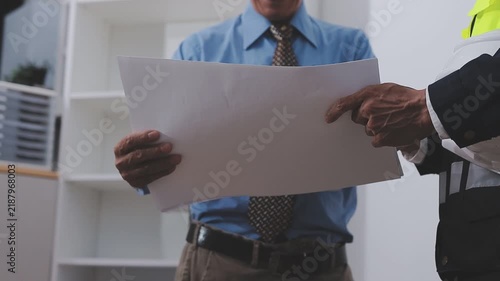 Close-up Of Person's engineer Hand Drawing Plan On Blue Print with architect equipment, Architects discussing at the table, team work and work flow construction concept