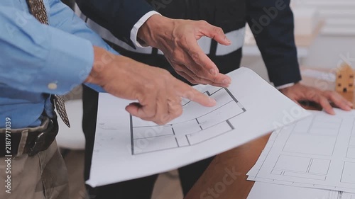 Close-up Of Person's engineer Hand Drawing Plan On Blue Print with architect equipment, Architects discussing at the table, team work and work flow construction concept