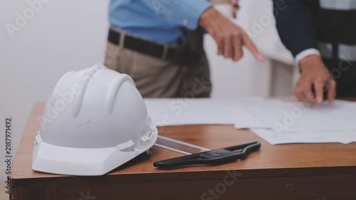 Close-up Of Person's engineer Hand Drawing Plan On Blue Print with architect equipment, Architects discussing at the table, team work and work flow construction concept