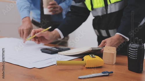 Close-up Of Person's engineer Hand Drawing Plan On Blue Print with architect equipment, Architects discussing at the table, team work and work flow construction concept