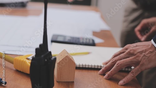 Close-up Of Person's engineer Hand Drawing Plan On Blue Print with architect equipment, Architects discussing at the table, team work and work flow construction concept