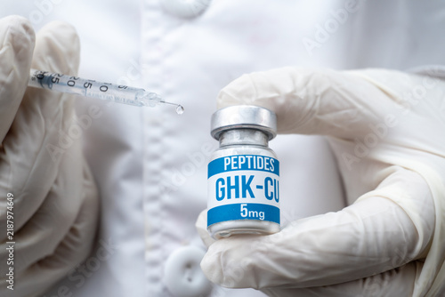 Doctor in Gloves Holding Insulin Syringe with Droplet and GHK-CU Peptide Vial