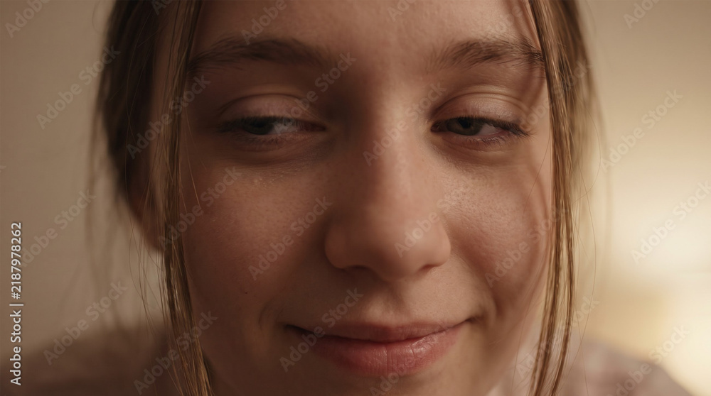 Fototapeta premium Extreme Close Up Portrait of Young Woman Smiling Slightly with Subtle Expression