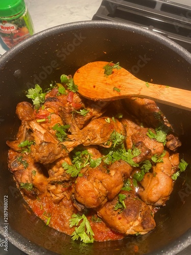 Quadro su tela Fresh Chicken Curry with Cilantro Garnish Cooking in Large Pot