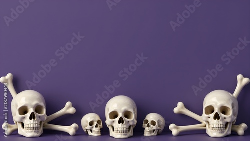 Halloween skull and crossbones composition on purple background, spooky human skulls with white bones, macabre holiday border