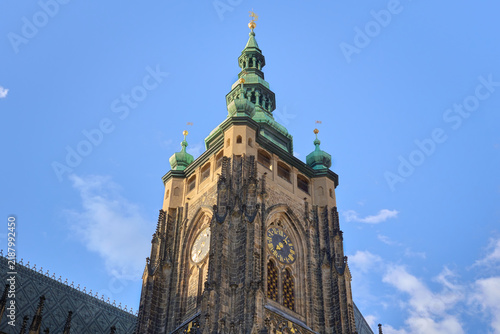 Detailed view of the Gothic apse, flying buttresses, and copper spires of St. Vitus Cathedral in Prague Castle, Czech Republic.