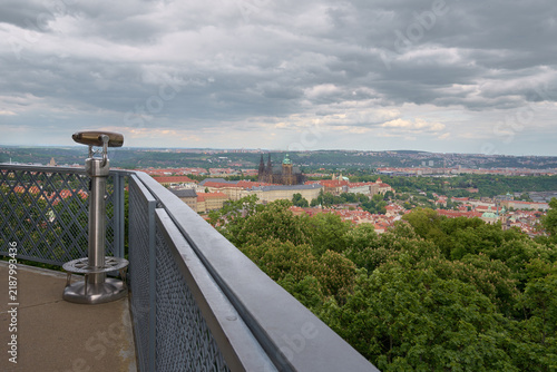 Panoramic view of Prague Castle and St. Vitus Cathedral skyline from Petrin Lookout Tower balcony with telescope, Czech Republic.