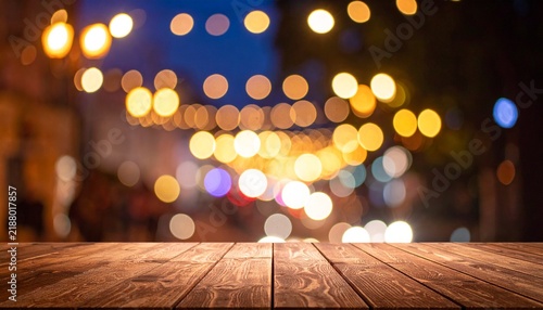 Wooden table, blurred bokeh background background. Neon light, night view, close-up. The general background of the interior, a dark background.
