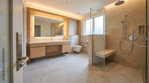 Modern Accessible home bathroom featuring a spacious roll-in shower and floating vanity