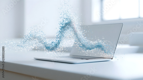 Abstract wave of blue light particles flowing from an open laptop on a white desk with abstract stream glowing