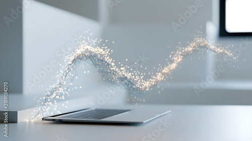 A laptop computer sitting on a white desk with glowing digital particles flowing above it with luminous sparkling particles