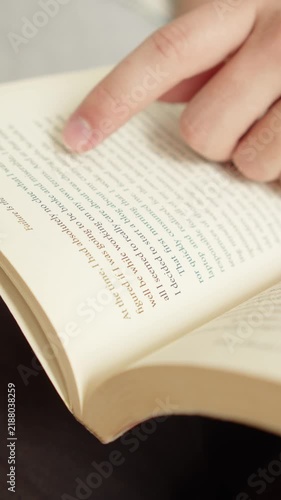 Close-up of hands holding an open book.
