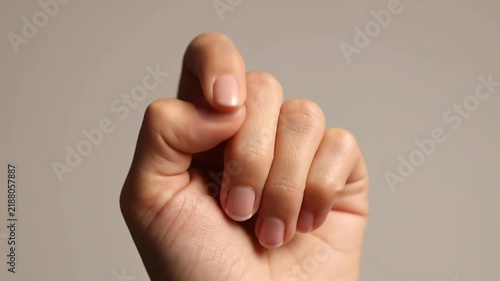Close-up of a fist clenched in the hand, close-up of a woman's fingers
