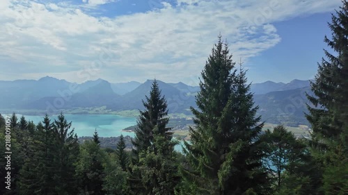 Aerial landscape footage with evergreen tree. Scenic nature over lake. Aerial view of mountain landscape. Landscape panorama. Scenic landscape with mountain lake in nature. Mountain peak aerial view
