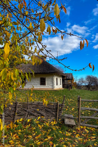 Golden autumn colors light up the countryside among old wooden houses and ancient churches in Ukraine, creating a warm nostalgic atmosphere.
