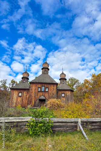 Golden autumn colors light up the countryside among old wooden houses and ancient churches in Ukraine, creating a warm nostalgic atmosphere.