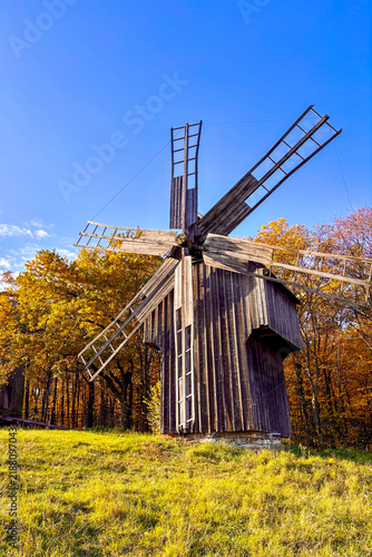 Golden autumn colors light up the countryside among old wooden houses and ancient churches in Ukraine, creating a warm nostalgic atmosphere.