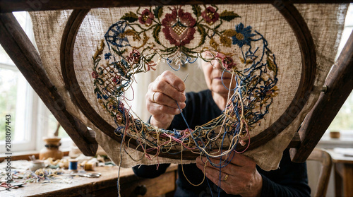 Woman Creating a Handmade Floral Embroidery Wreath with Needle and Thread