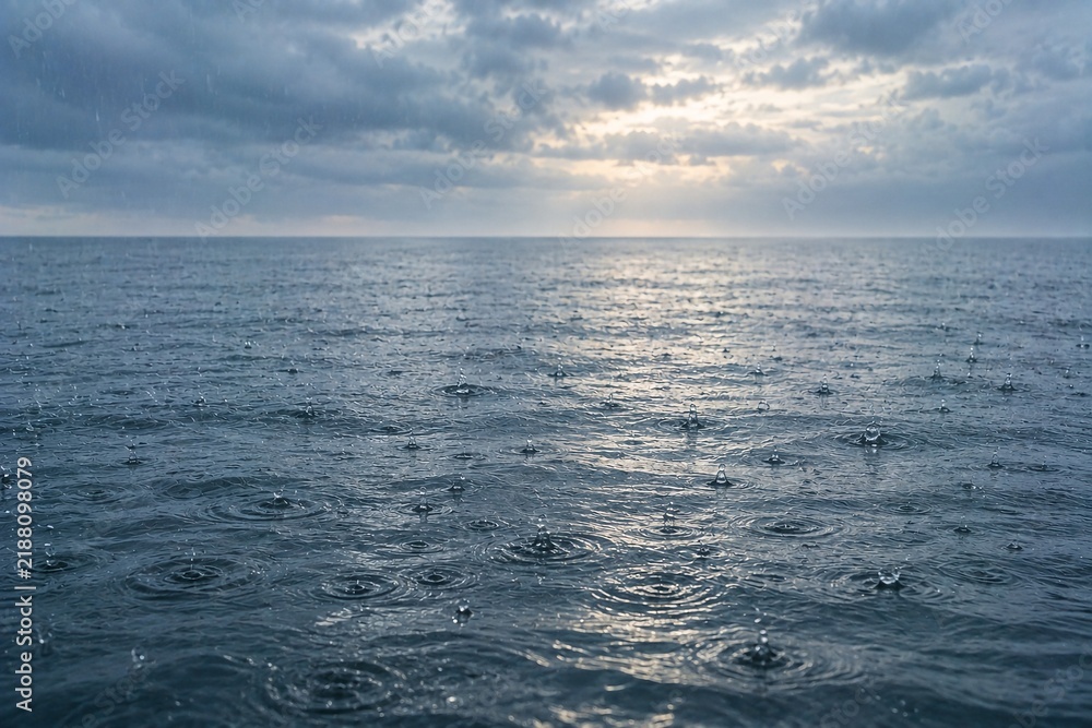 Obraz premium Raindrops Creating Ripples on Calm Ocean Surface