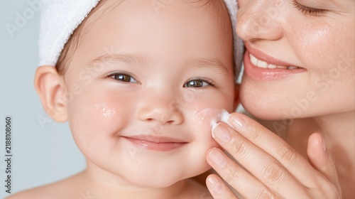 Smiling baby held close beside a mother's face, happy infancy, maternal love, family bonding, joyful childhood portrait.
