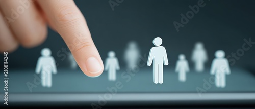 Digital interaction concept a hand selecting a human figure from a group of silhouettes on a tablet screen symbolizing choice and connection