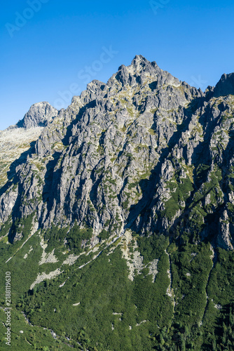 The complex geological structure of mountain peaks, visible in the landscape.