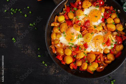 Shakshuka Style Eggs with Potatoes and Sweet Peppers. Top view, above