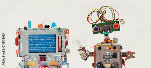 Robot computer with blue screen of repeated symbols forming heart, funny robot with blue-red eyes holding miniature bulb. Digital creativity concept, technology poster, gadget banner