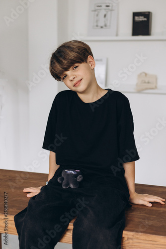 European teenager boy 11-12 years old. Boy model in a black T-shirt. Smiling
